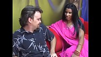Young Indian lady gives an older man a blow job on a red couch