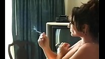 Inviting slut in see-through raiment smokin' a cigarette