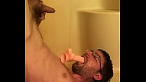 Skinny nerd pisses on his own face with dildo in his mouth