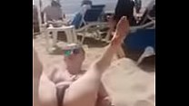 Woman on the beach shows us