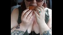 Cute redhead eats fast food with tits out