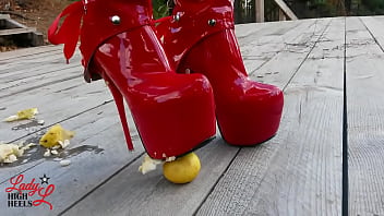 Lady L crush apples with extreme sexy red boots.