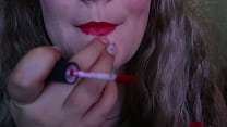 CUTE WOMAN PAINTS HER LIPS RED AND SMOKES a CIGARETTE, I HOPE YOU LIKE IT