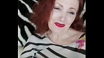 Red-haired lady shows her breasts in a white-black blouse